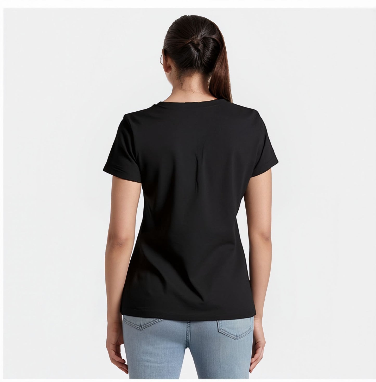 Back view of a woman wearing a plain black t-shirt with short sleeves and light blue jeans. Her hair is tied back in a ponytail, and she is standing against a plain white background.

