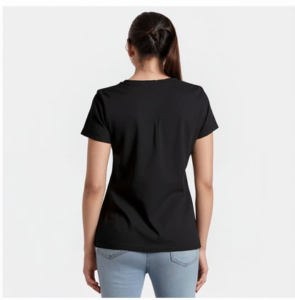 Back view of a woman wearing a plain black t-shirt with short sleeves and light blue jeans. Her hair is tied back in a ponytail, and she is standing against a plain white background.

