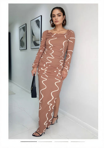 Model wearing a long bodycon dress with abstract white swirl print, styled with black handbag and heels