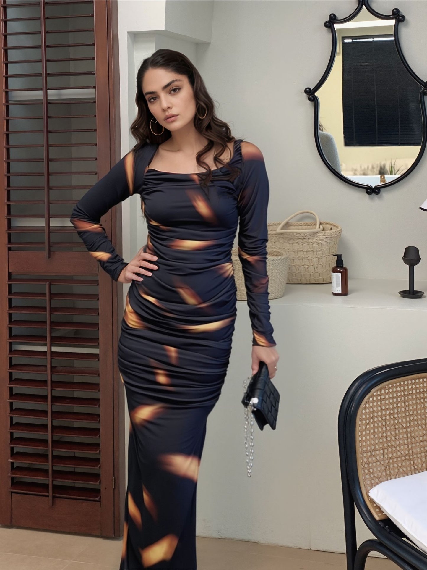 Full-length black and orange printed ruched dress with long sleeves – partywear outfit for women
