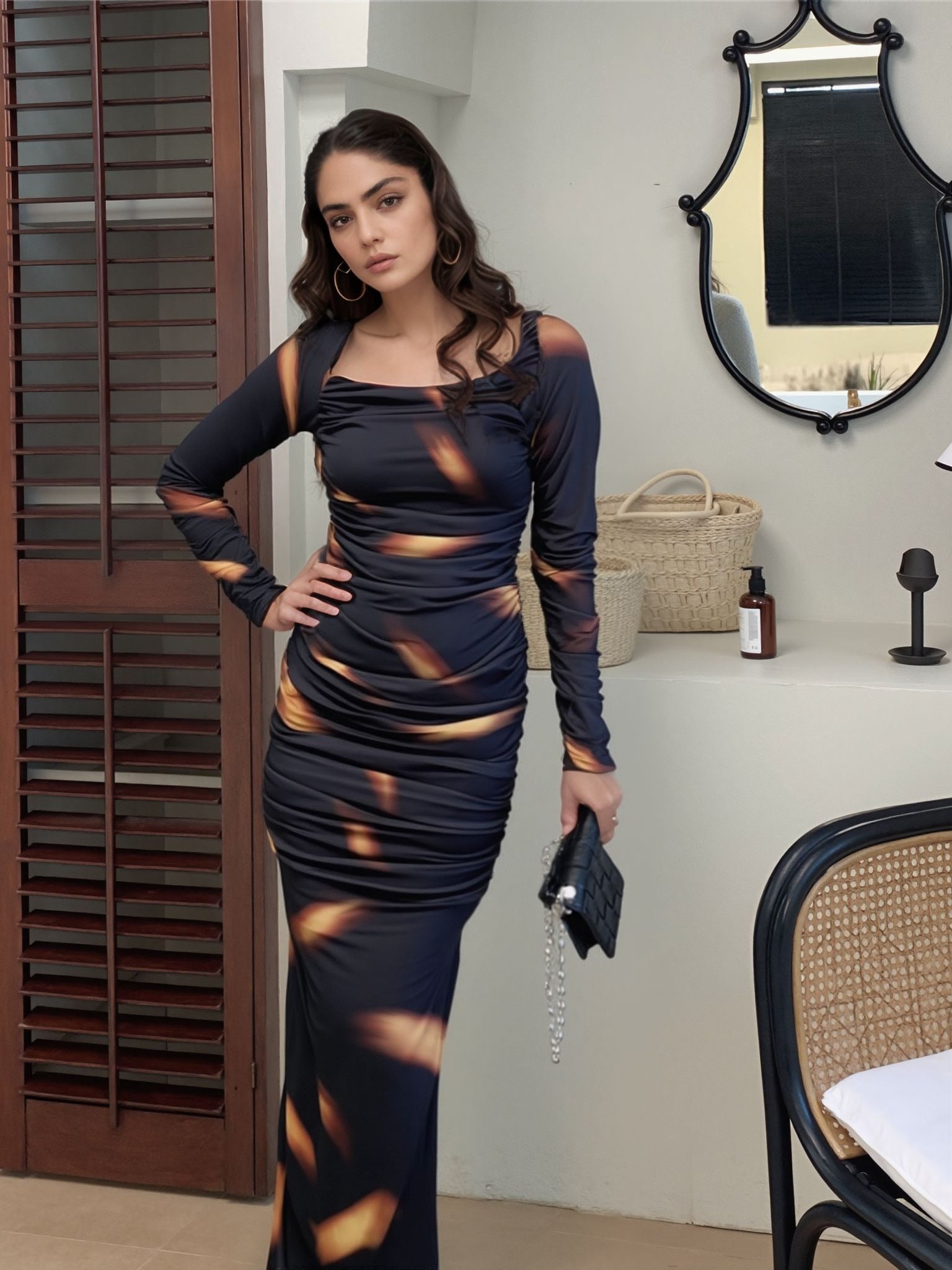 Full-length black and orange printed ruched dress with long sleeves – partywear outfit for women
