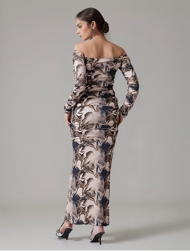 Back view of woman wearing off-shoulder marble print long bodycon dress with ruched details.