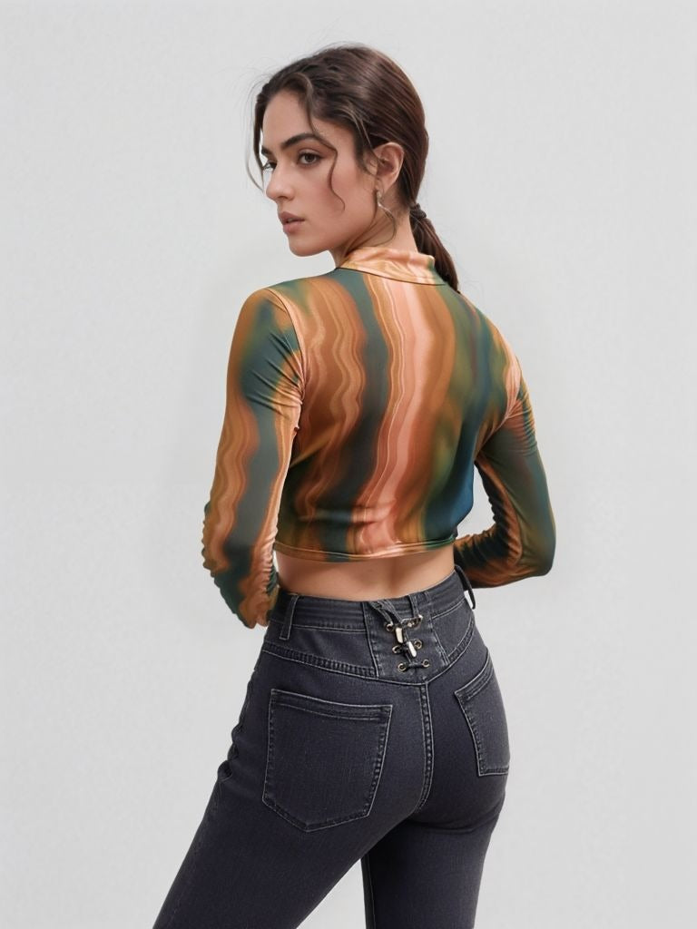 Back view of model in swirl marble print ruched mesh crop top with high neckline and full sleeves, styled with high-waisted charcoal grey jeans