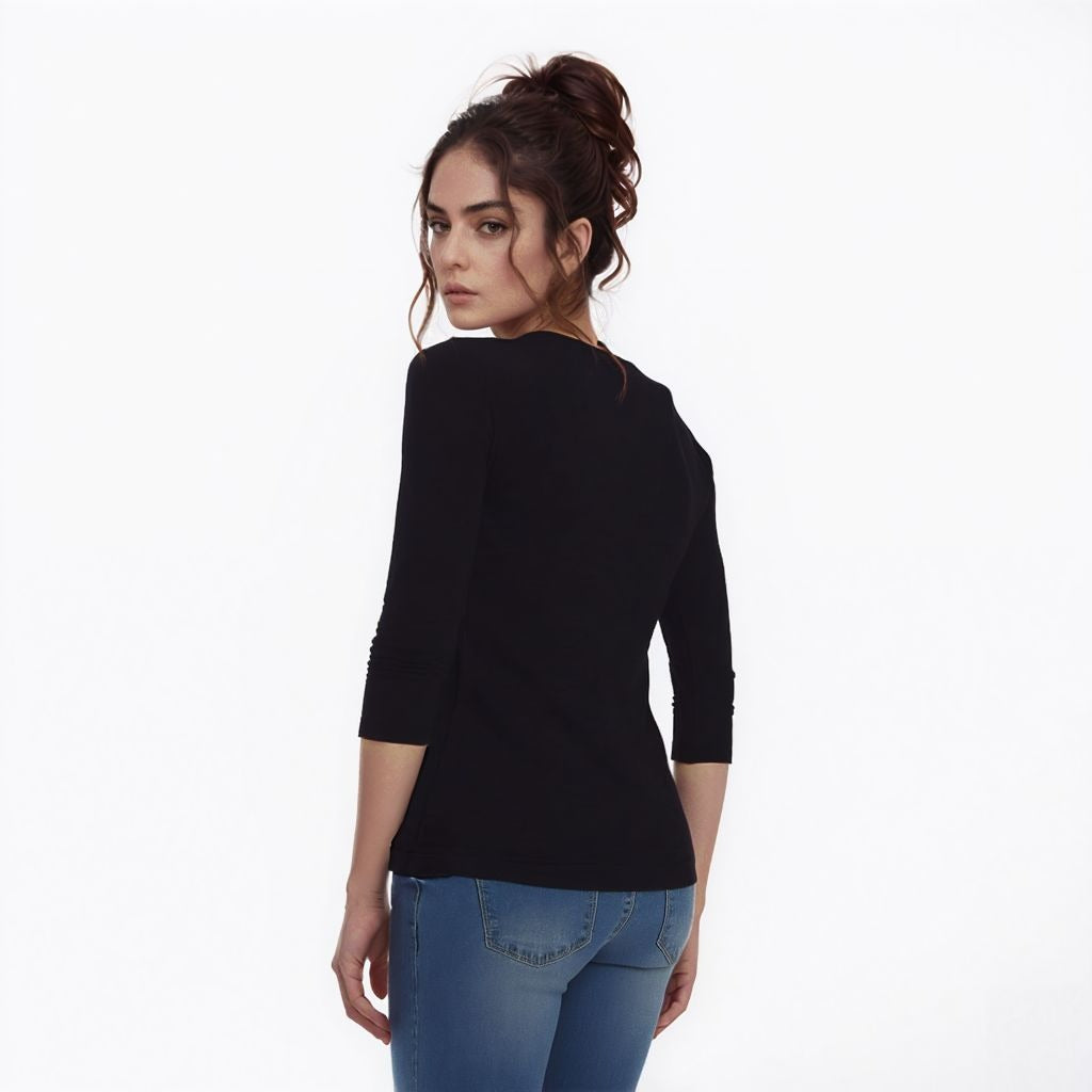 Woman wearing a black top and blue jeans on a white background showing backview
