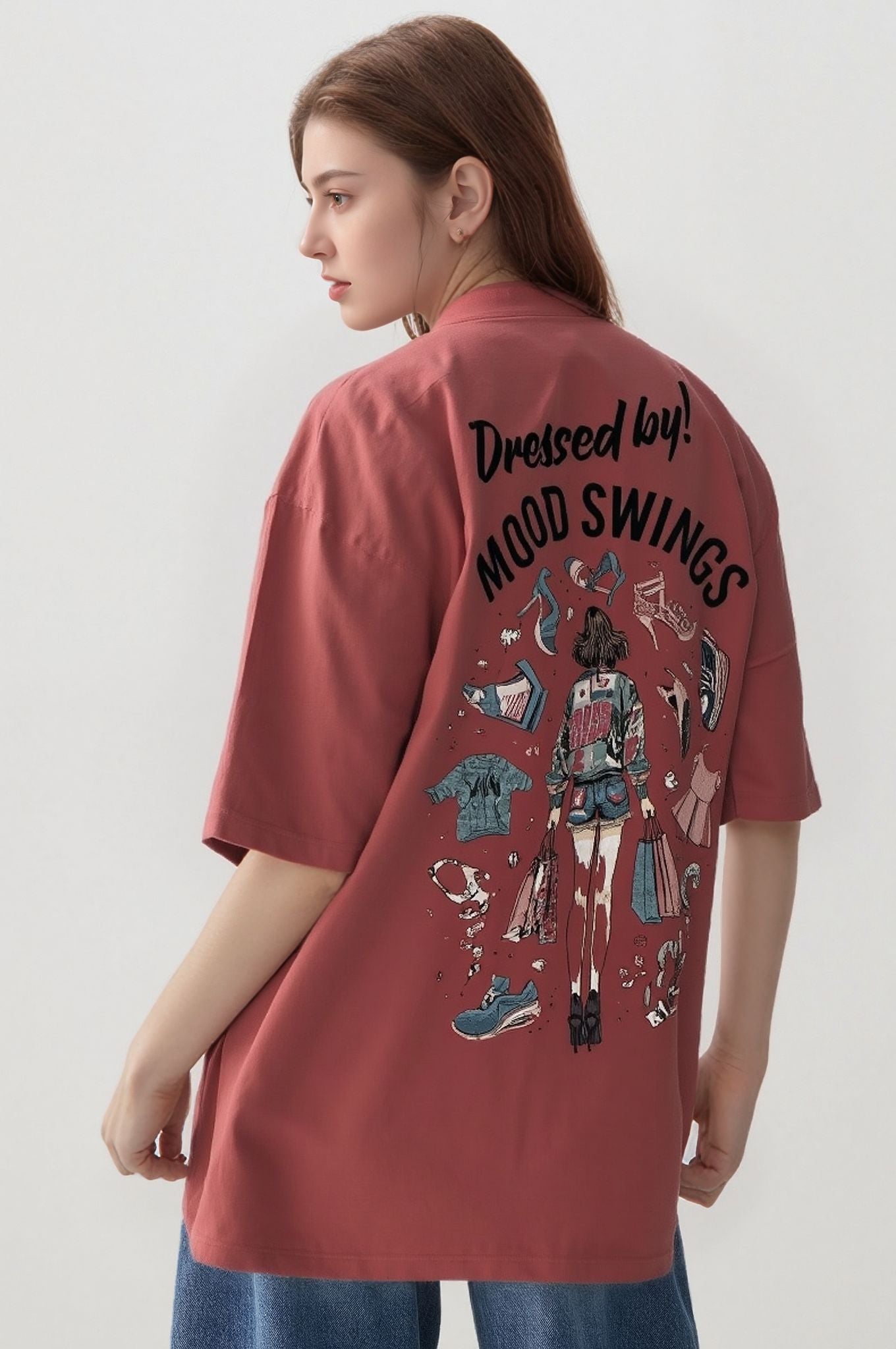 Person wearing a coral shirt with graphic designs and text on the back against a white background