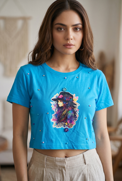 Front view of women’s blue graphic crop top with pearl and rhinestone embellishments.