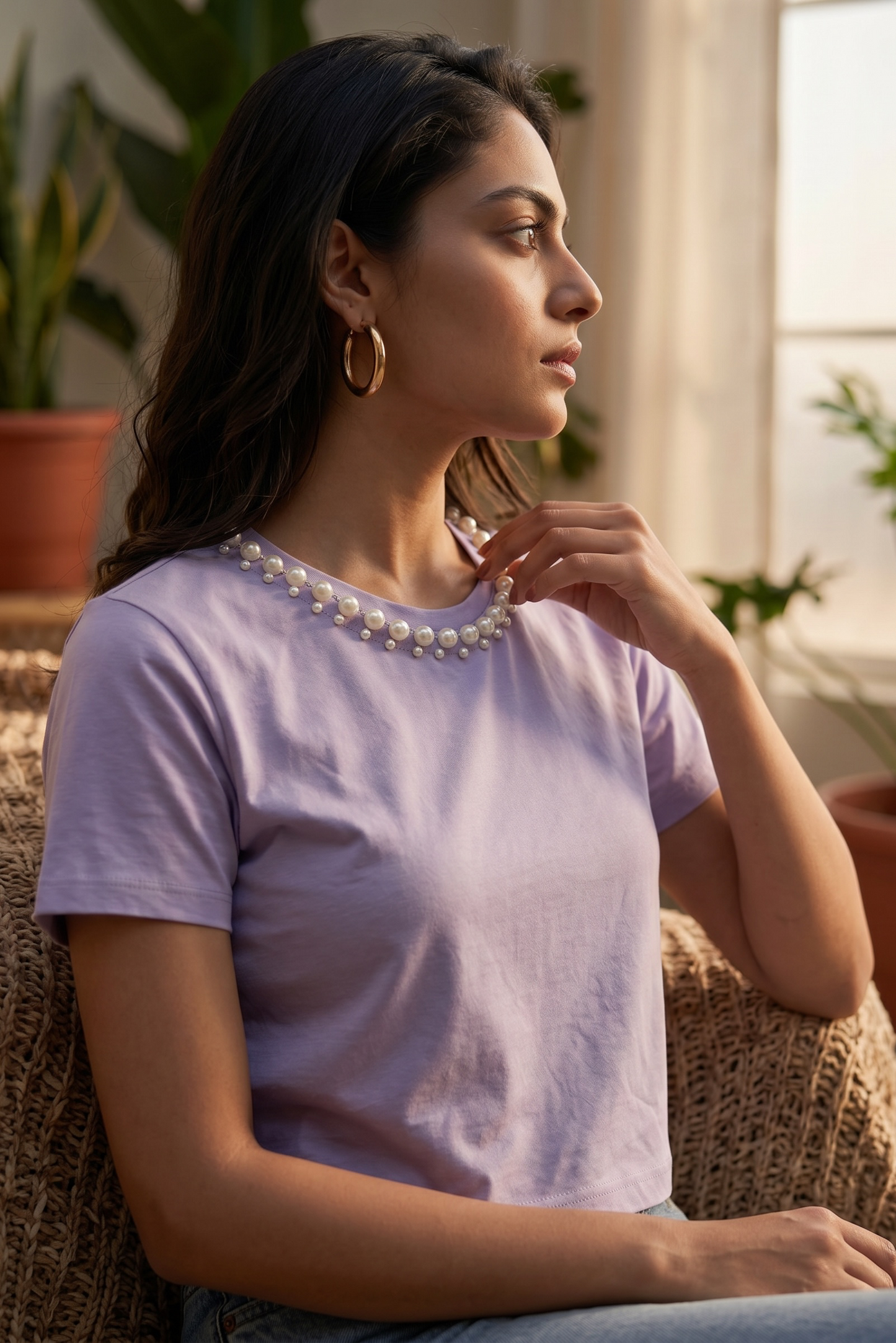 Side profile of lavender crop top featuring an elegant pearl embellished neckline.
