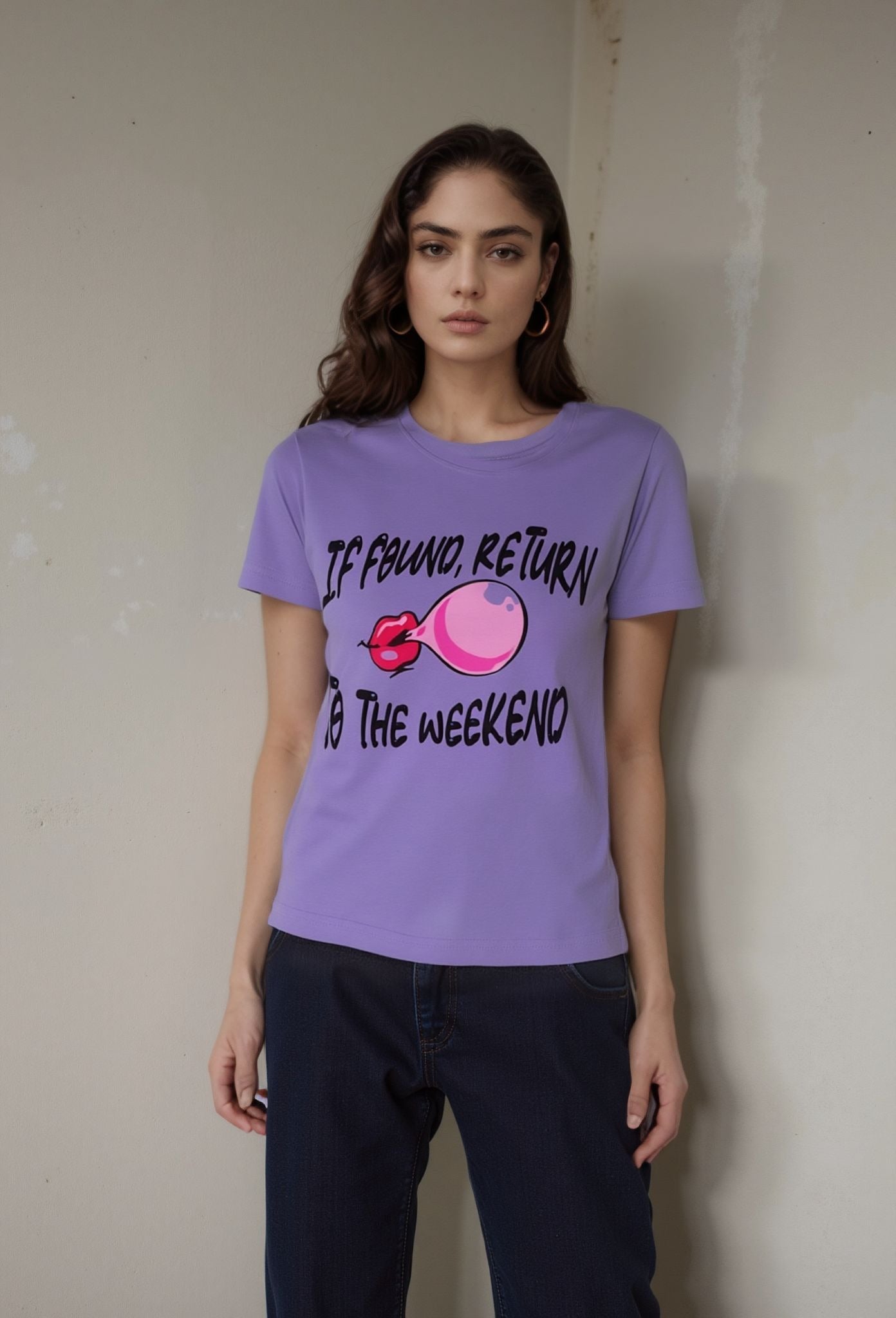 Lavender t-shirt with bold “If Found, Return to the Weekend” graphic and lips blowing bubblegum
