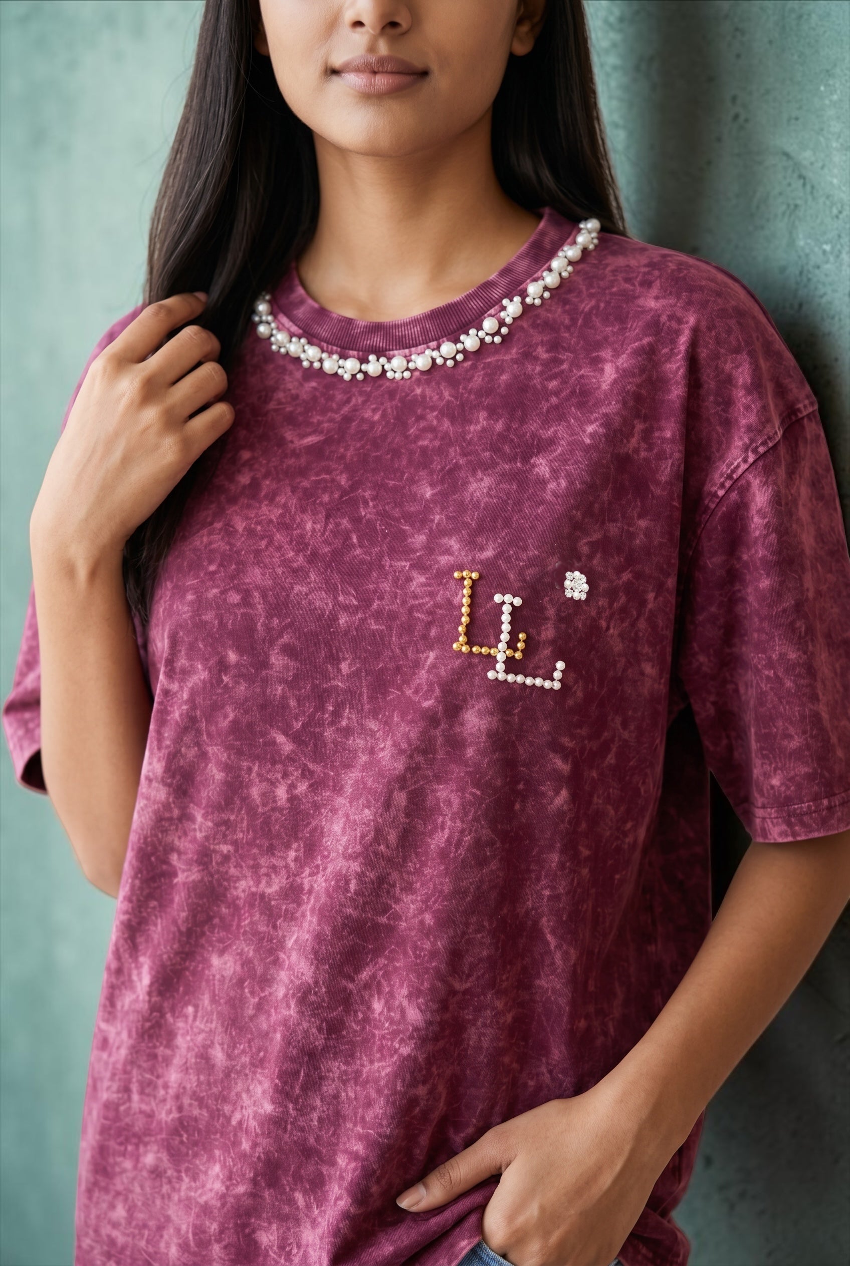 Front view of women’s maroon acid wash oversized cotton T-shirt with pearl embellished neckline.
