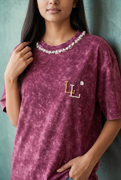 Front view of women’s maroon acid wash oversized cotton T-shirt with pearl embellished neckline.
