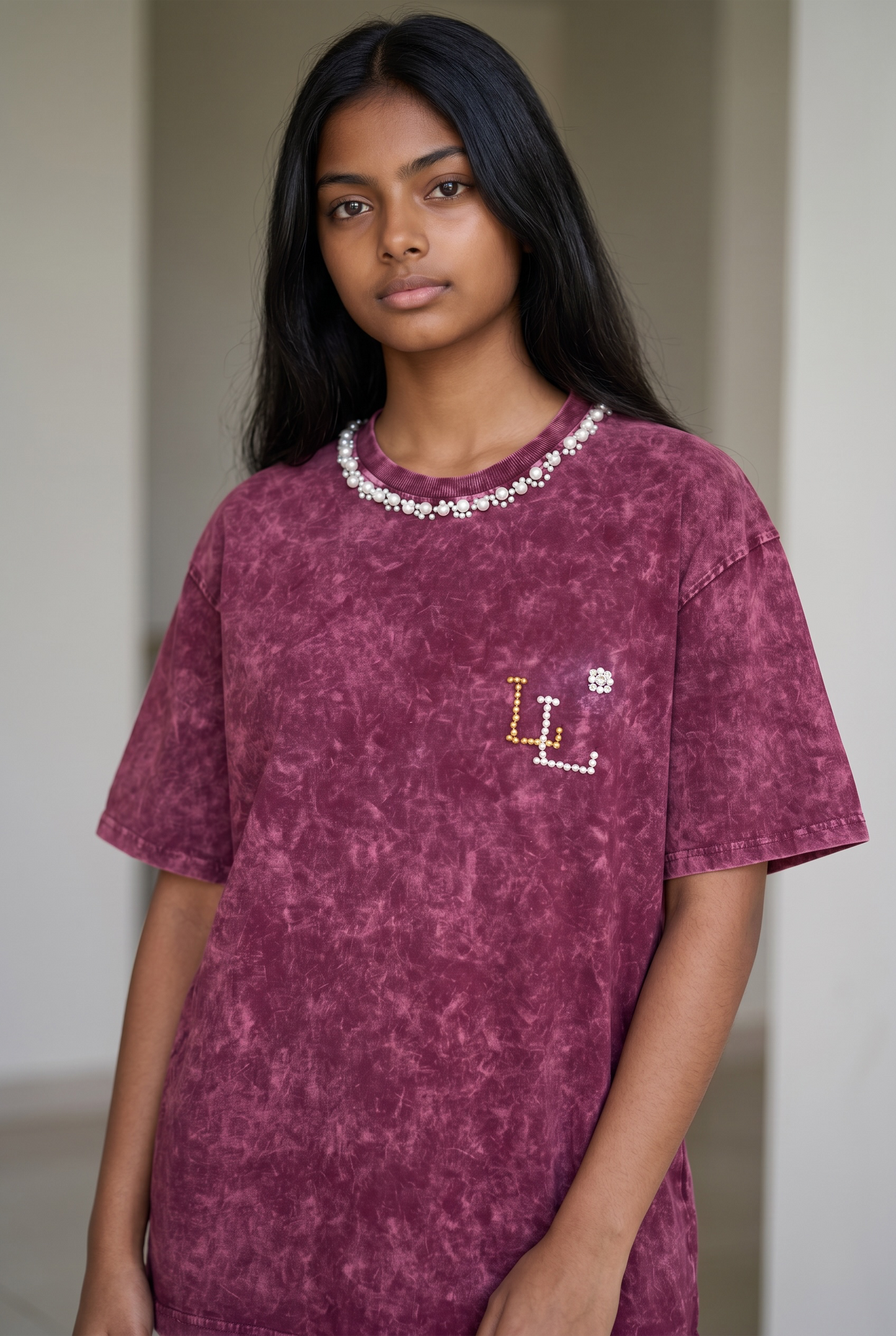 Lifestyle image of maroon acid wash oversized cotton T-shirt with pearl neckline and relaxed drop shoulder fit.