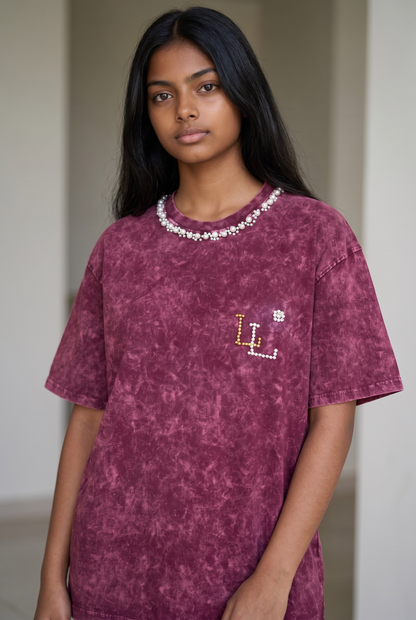 Lifestyle image of maroon acid wash oversized cotton T-shirt with pearl neckline and relaxed drop shoulder fit.